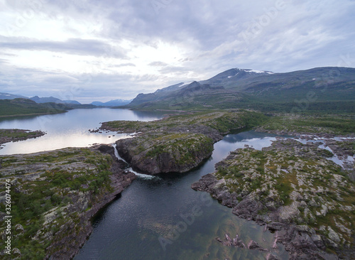 Mountain Waterfall Landscape. Location: Stuor Muorkke National Park In Northern Sweden, Scandinavia. Date: July, 2018.  photo