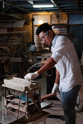 Handsome man wearing glove and protective glasses, , working at factory,Handmade design,,blurry light around