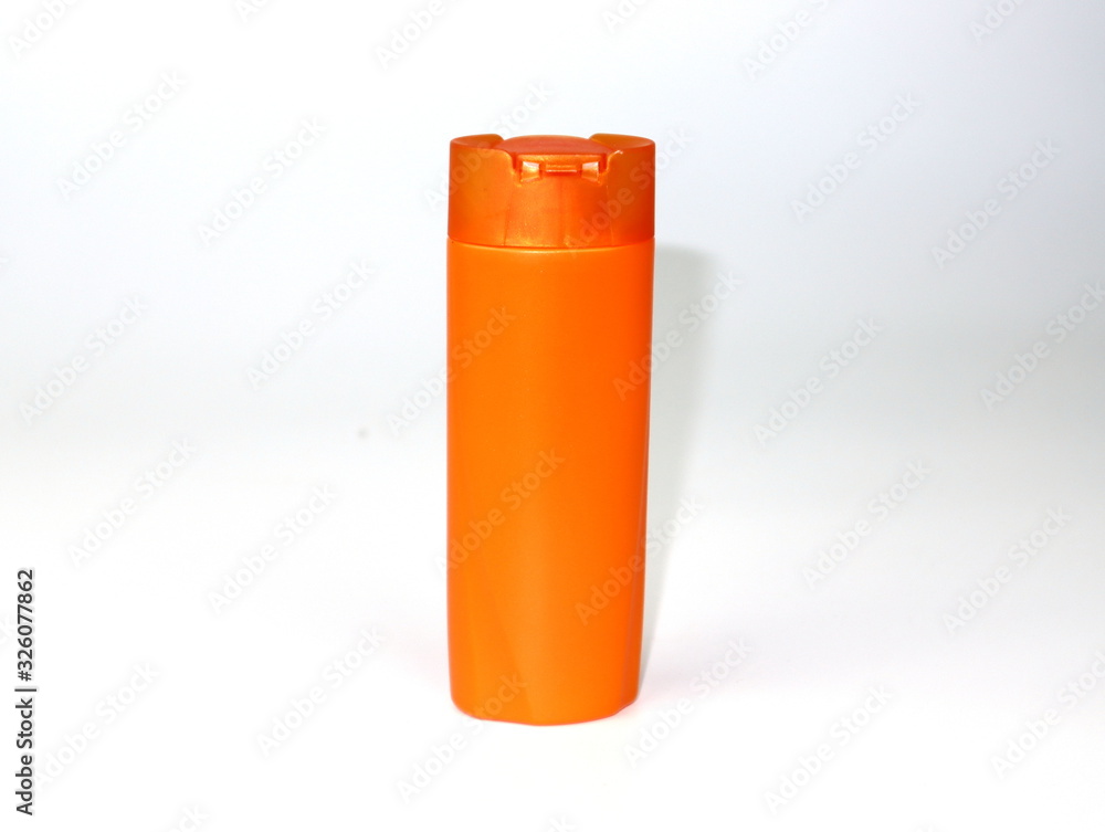 Blank orange plastic pump bottle used for shampoo or soap isolated on white background Blank orange plastic pump bottle used for shampoo or soap isolated on white background