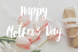 Happy mother's day. Happy mother's day text and pink tulips with gift box on white background. Stylish soft image. Floral Greeting card. Happy Mothers day. Handwritten lettering