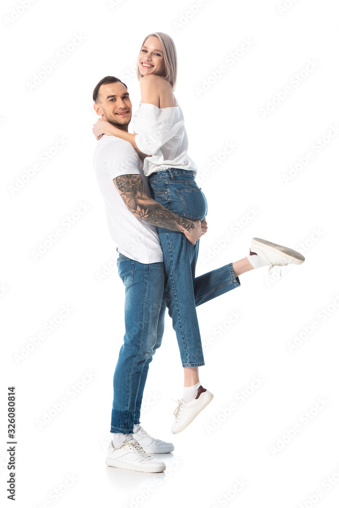 happy young tattooed man holding girlfriend isolated on white happy young tattooed man holding girlfriend isolated on white
