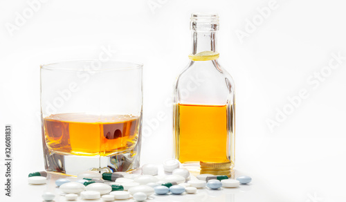 Medicines and alcohol isolated on white background, addictive