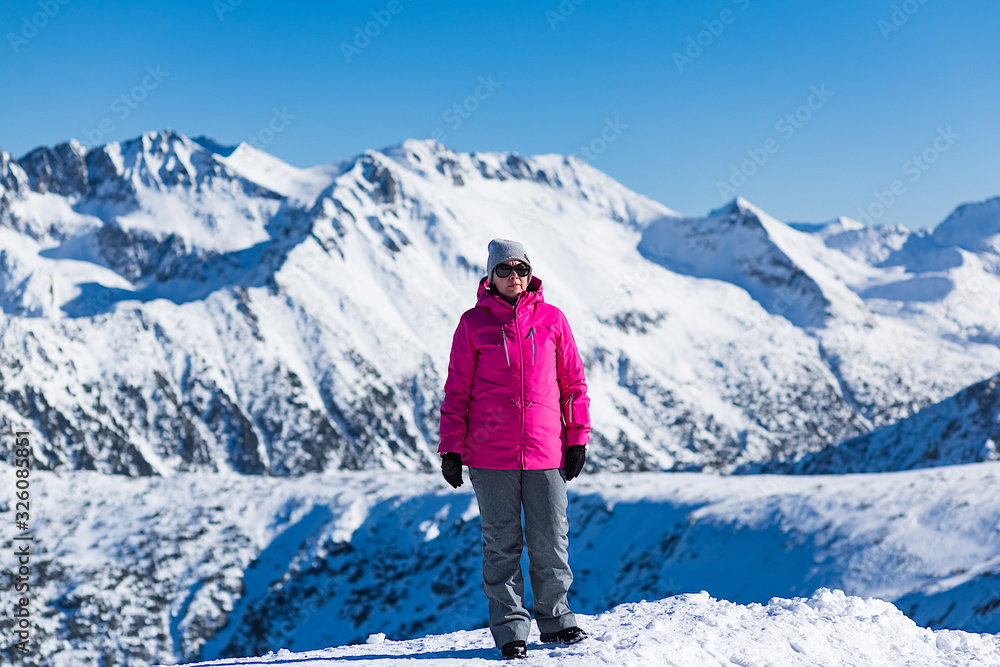 middle-aged brunette on a background of mountains