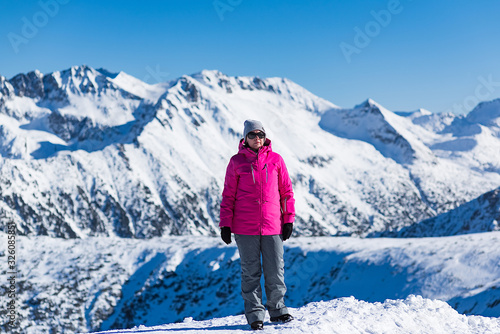middle-aged brunette on a background of mountains