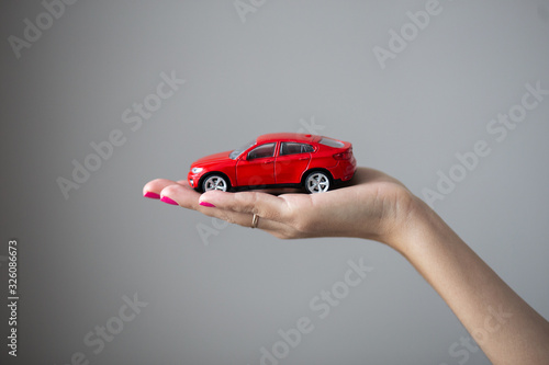 Closeup photo of woman hand holds a little car toy