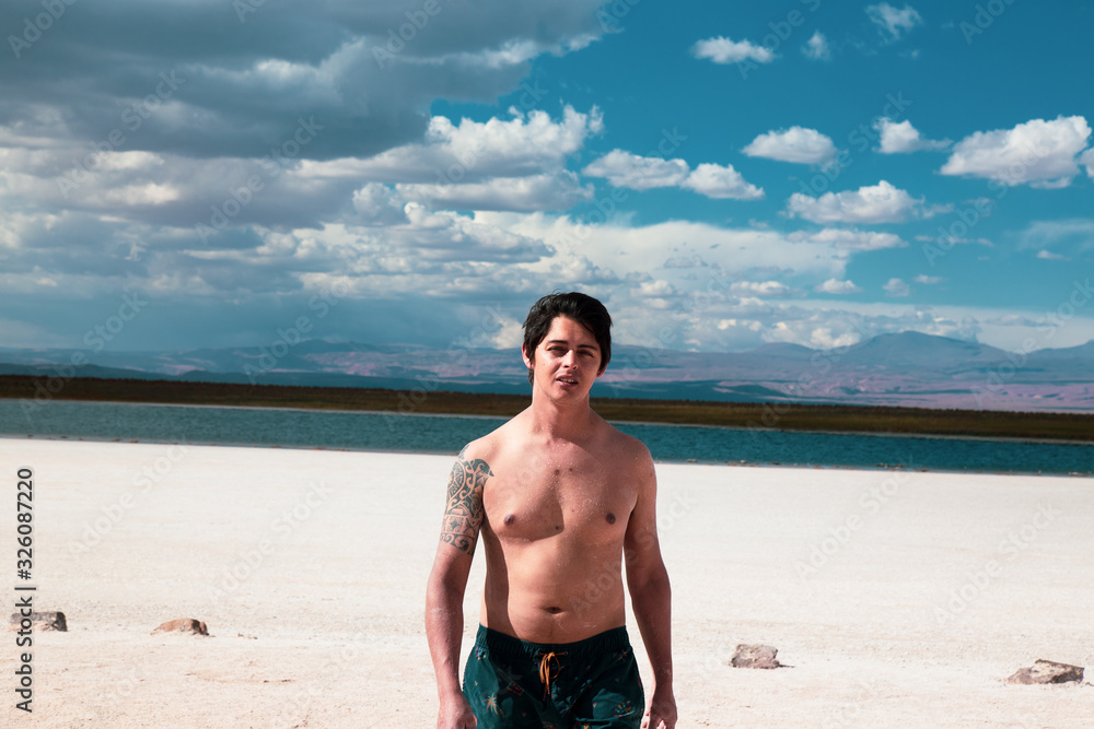 man walking through a turquoise landscape