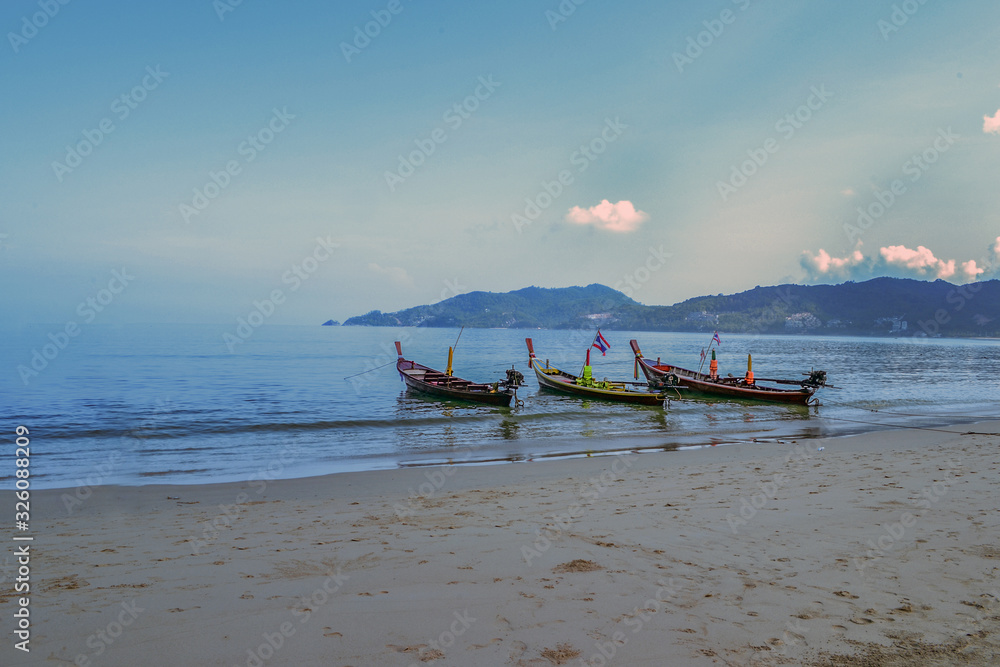 boat on the beach in phuket, thailand boat on the beach in phuket, thailand