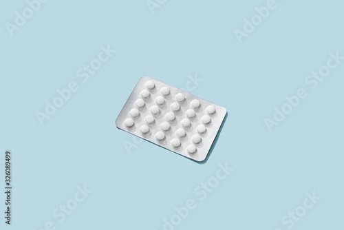 Wallpaper Mural White pills medical tablet packaging lay flat and isolated on blue background. Torontodigital.ca