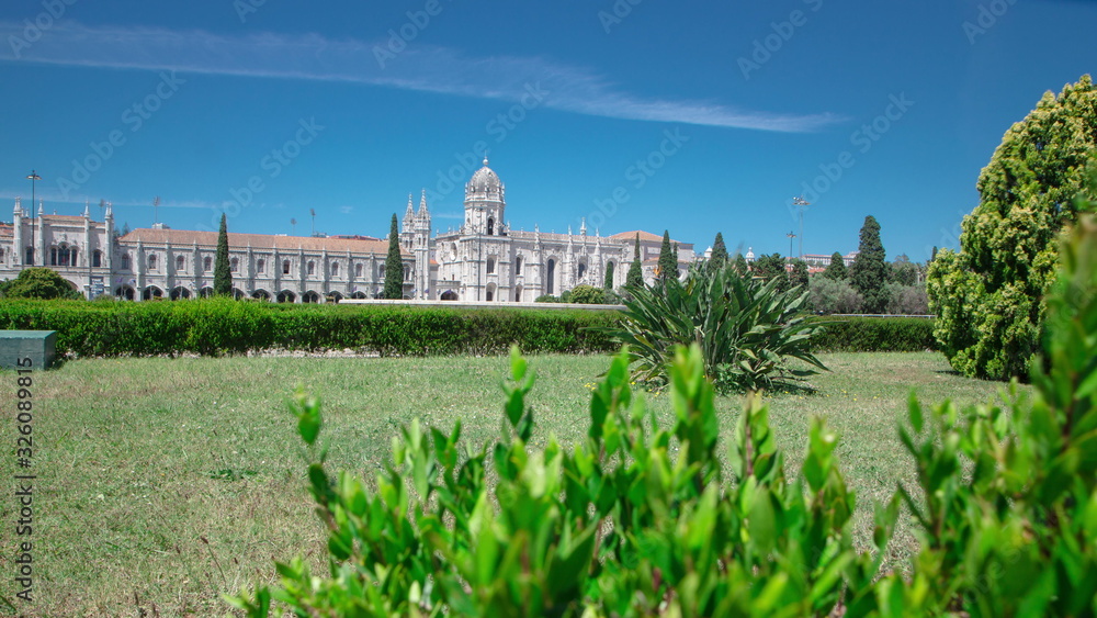 The Jeronimos Monastery or Hieronymites Monastery with lawn and bushes is located in Lisbon, Portugal timelapse