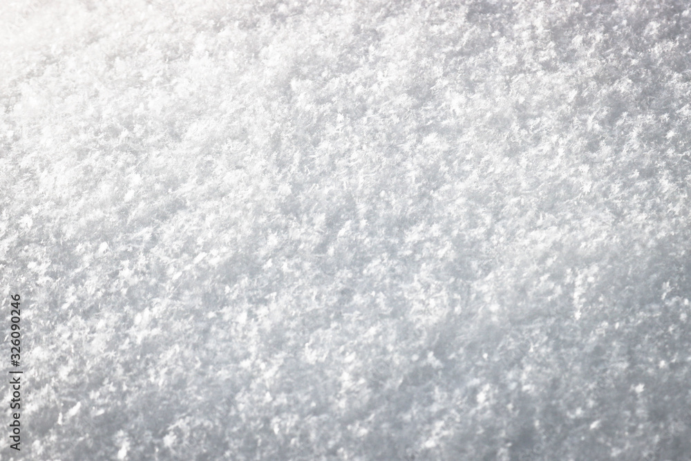 The texture of freshly fallen snow. Christmas template for design. Clearly visible individual snowflakes. Winter background. The texture of freshly fallen snow. Christmas template for design. Clearly visible individual snowflakes. Winter background.