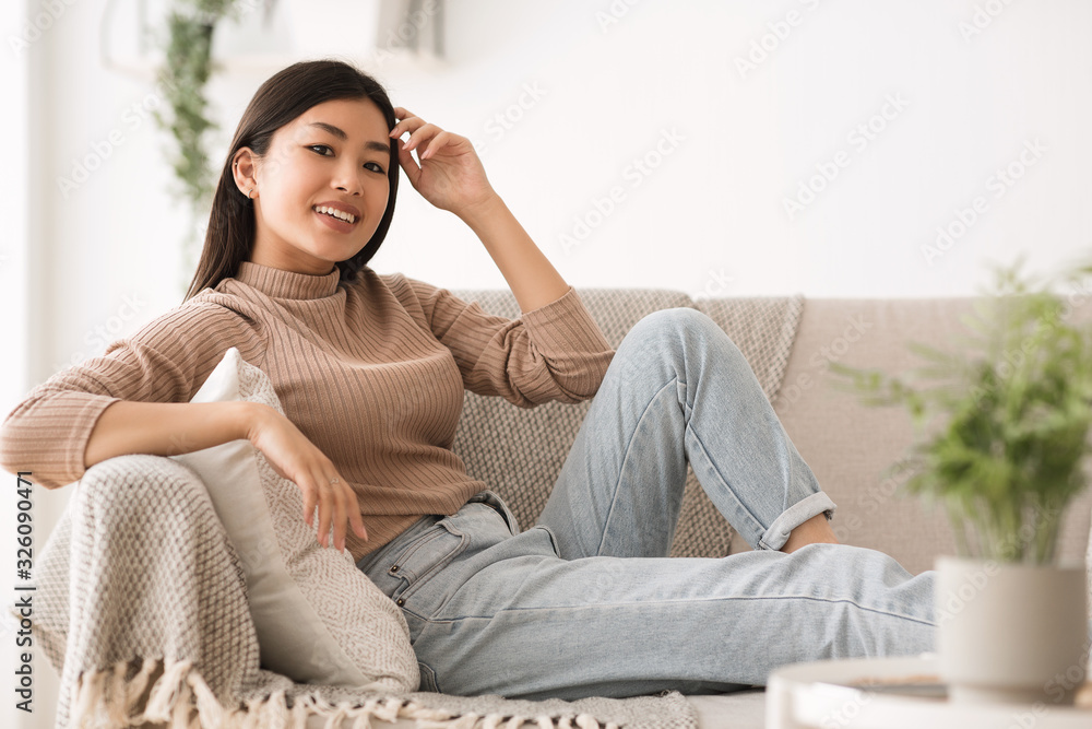 Calm smiling girl resting on sofa at home Calm smiling girl resting on sofa at home