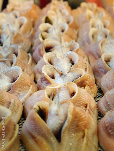 Striped dry snakehead fish selling at street market. Bangkok, Thailand.