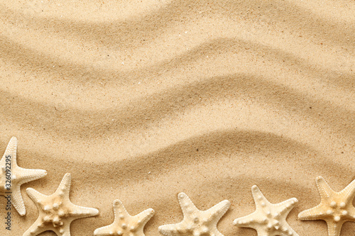 Starfishes On Wavy Sand Background