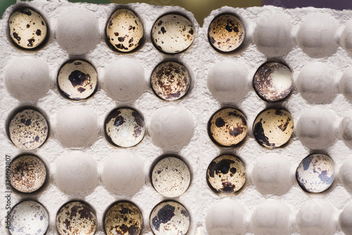 Quail eggs in cardboard packaging in random order..Vegetarian organic eco food.