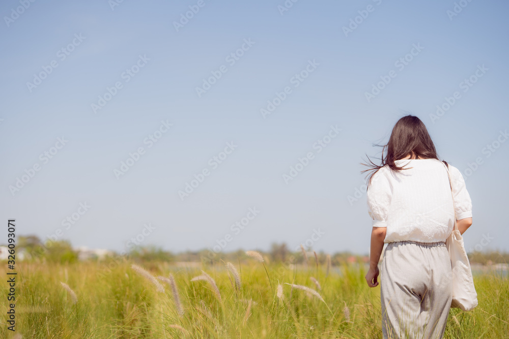 solo woman travel during take photo with greensward and clear sky background on summer season solo woman travel during take photo with greensward and clear sky background on summer season