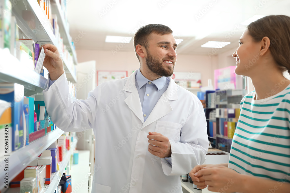 Professional pharmacist working with customer in modern drugstore
