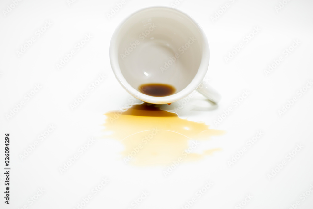 Coffee spilled from a cup stained on the white desk surface Coffee spilled from a cup stained on the white desk surface