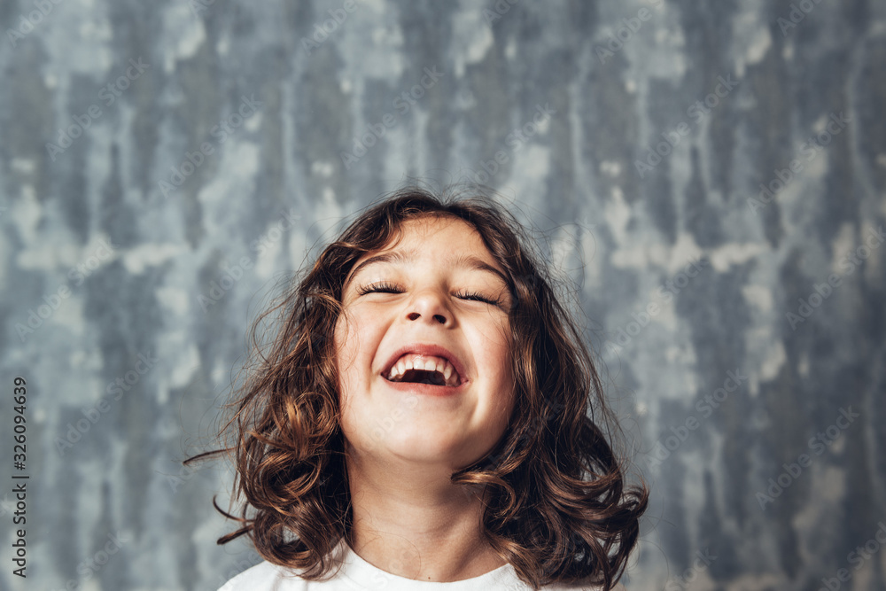 portrait of a happy little girl laughing portrait of a happy little girl laughing