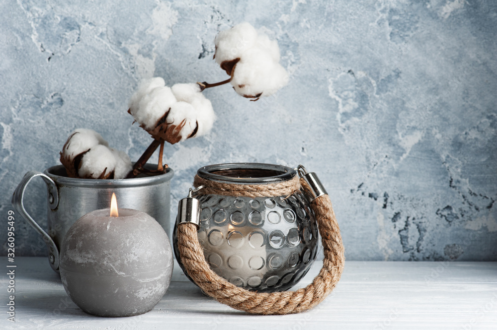 Scandinavian interior with cotton flowers and lit candles - obrazy, fototapety, plakaty 