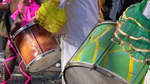 Drummer plays samba on the drum, at the carnival, slow motion, closeup. photo