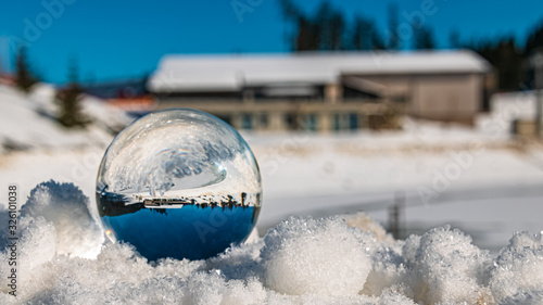 Crystal ball on snow crystals alpine winter landscape shot at Flachau, Salzburg, Austria © Martin Erdniss