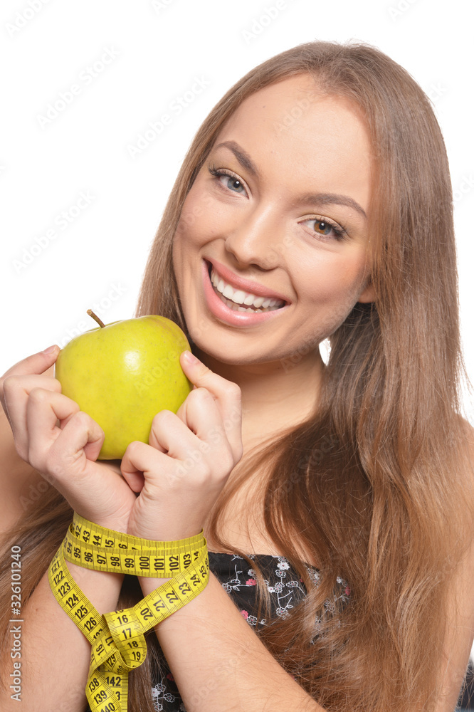Portrait of beautiful young woman with green apple and measuring tape Portrait of beautiful young woman with green apple and measuring tape