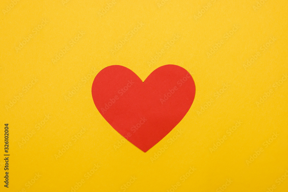 red crafted heart on yellow background. blood day