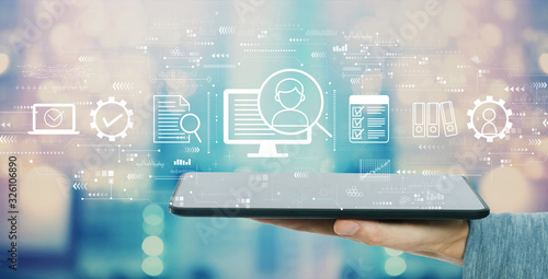 Document management system concept with man holding a tablet computer