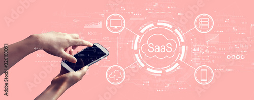 SaaS - software as a service concept with person holding a white smartphone