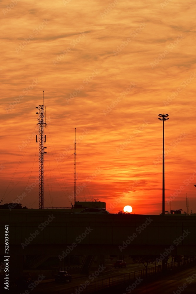 Wireless telephone pole and orange-yellow sky In the early morning of the day	