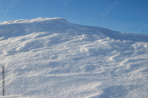 Snowdrift. Snow drift. Applied wind a large pile of snow during blizzards and snow falls. © Andrey
