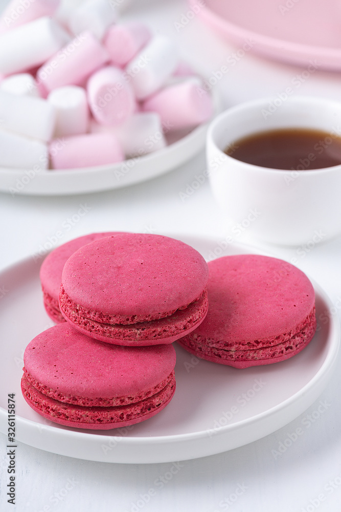 Macaroons, marshmallows and coffee on a white wooden table. Macaroons, marshmallows and coffee on a white wooden table.