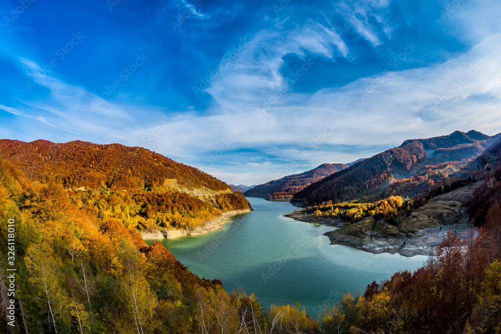 Beautiful autumn landscape with golden colored trees on the shores of Siriu lake, Siriu Dam, Buzau River Valley