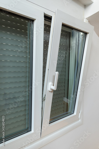 Obraz na płótnie Double tilt and turn aluminum thermal break window with vertical fly screen and rolling shutter, casement window with European w salonie