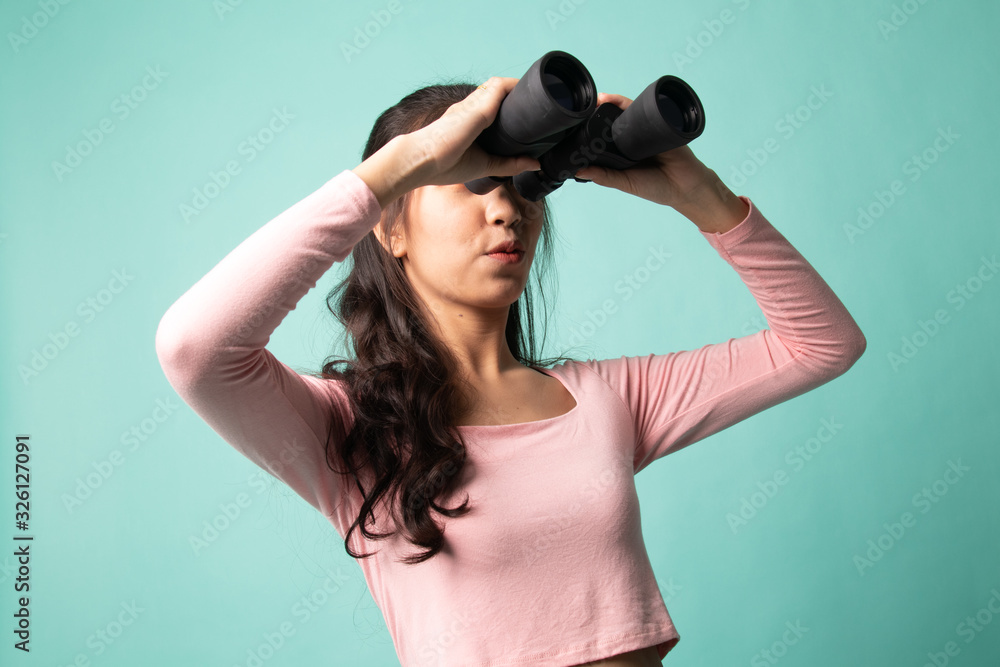 Young Asian woman with binoculars. Young Asian woman with binoculars.
