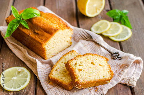 Canvas Print Lemon pound cake on rustic wooden background with lemon.
