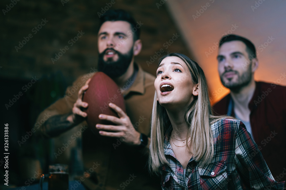 Excited sport fans watching rugby match on TV at home. Excited sport fans watching rugby match on TV at home.