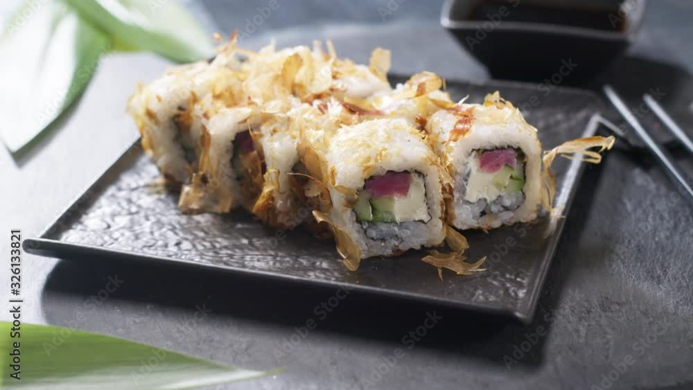 Shot of sushi roll set on black slate background food fish philadelphia japanese salmon delicious sushi rice cucumber meal traditional wasabi fresh healthy gourmet raw cuisine Shot of sushi roll set on black slate background food fish philadelphia japanese salmon delicious sushi rice cucumber meal traditional wasabi fresh healthy gourmet raw cuisine