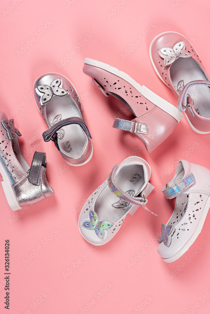 Beautiful baby shoes on a pink background. For children. Stylish pink female shoes on pastel background, copy space. New sneakers on pink background. Beauty and fashion concept. Flat lay, top view. Beautiful baby shoes on a pink background. For children. Stylish pink female shoes on pastel background, copy space. New sneakers on pink background. Beauty and fashion concept. Flat lay, top view.
