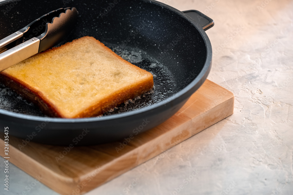 Crispy white bread toasters with butter on a wooden board Crispy white bread toasters with butter on a wooden board