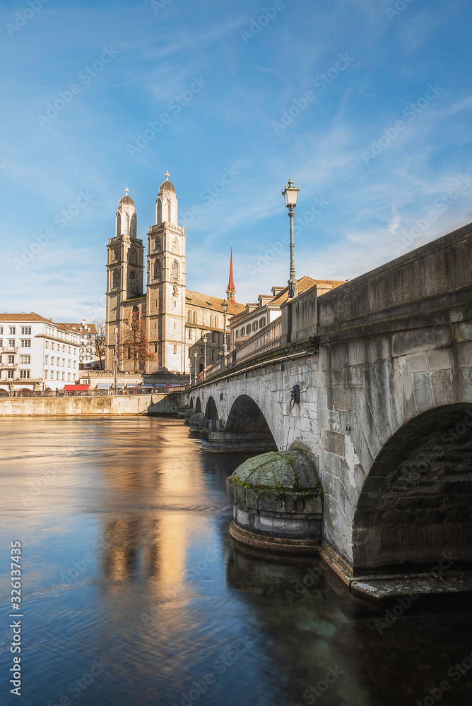 Zurich cityscape with old bridge and church on a sunny day