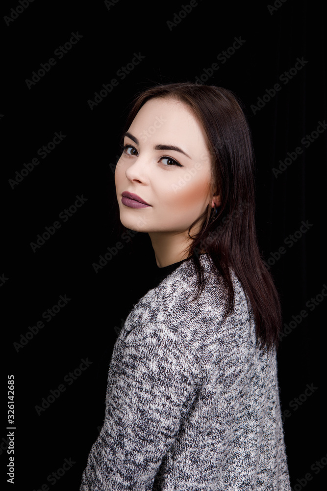 Cute girl dressed in casual wear is smiling on black background Cute girl dressed in casual wear is smiling on black background