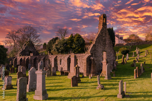 The Ruins of Kirkoswald Church & Graveyard Ayrshire with a blazing red Sunset made famous by Robert Burns. photo