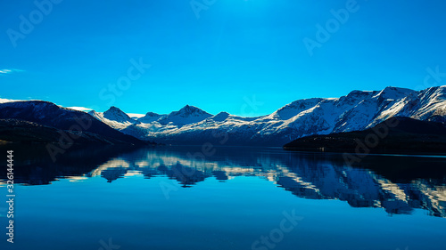 waterreflections infront of snowy mountains and a blue vlear sky © RobertNiklas