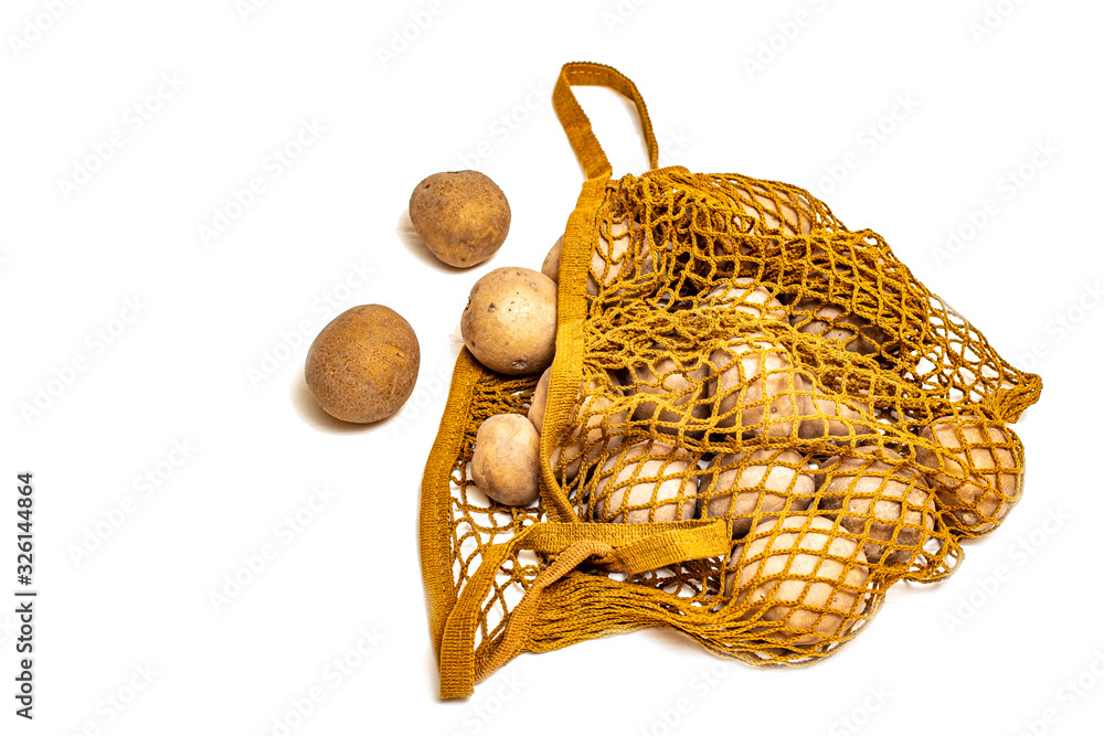 Fototapeta premium Potatoes in a string bag on a white background.