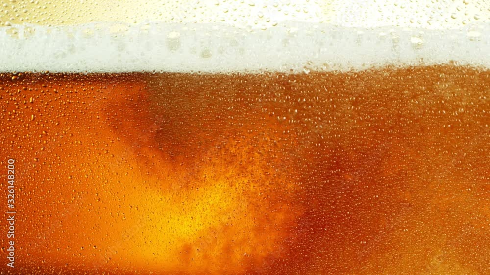 Super slow motion of macro shot of beer drink, close-up. Filmed on high speed cinema camera, 1000 fps. Super slow motion of macro shot of beer drink, close-up. Filmed on high speed cinema camera, 1000 fps.