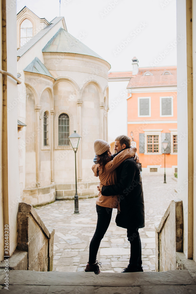 Loving couple cuddling in the courtyard of the old town. Loving couple cuddling in the courtyard of the old town.