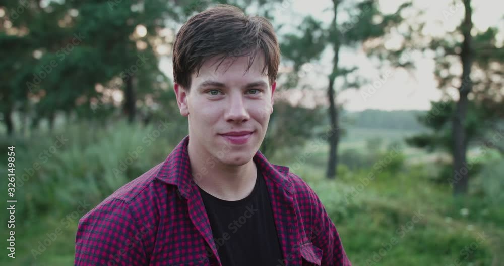 Portrait of handsome man smiling at camera on summer nature Portrait of handsome man smiling at camera on summer nature