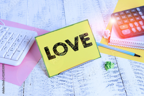 Word writing text Love. Business photo showcasing feeling of strong or constant affection for a demonstrating Feel deep roanalysistic Notepaper stand on buffer wire in between computer keyboard and photo