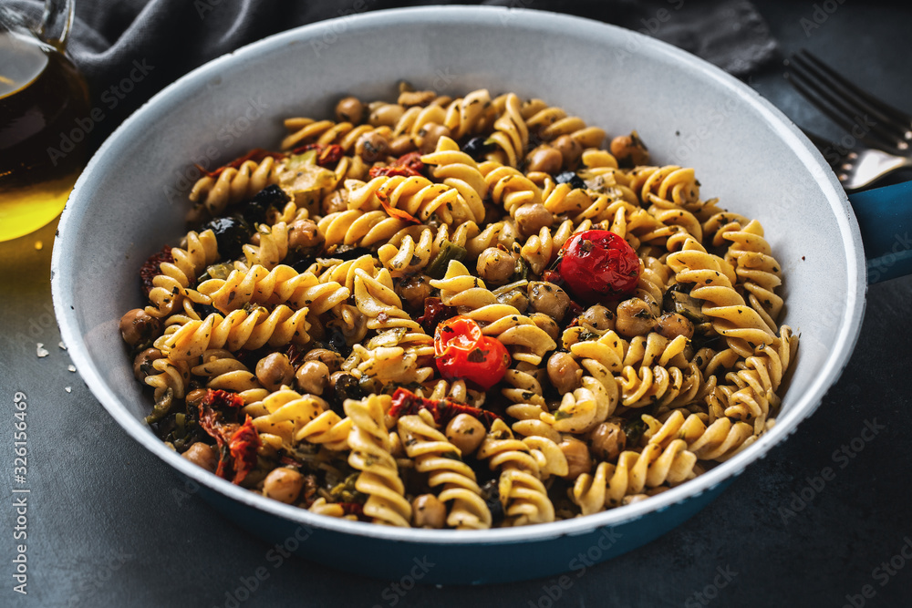 Fototapeta premium Vegan pasta with vegetables and chickpeas